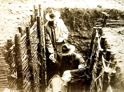 U.S. Army Hospital Corps soldiers in the first line trenches rendering aid, AEF, WWI (32832945521)