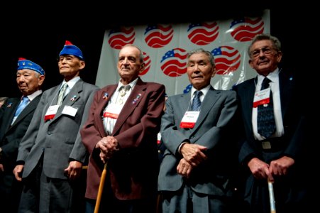 U.S. Army veterans from the 141st Infantry Regiment and the 442nd Regimental Combat Team stand during the 65th Anniversary Tribute dinner photo