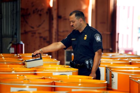 U.S. Customs & Border Protection Officer Inspects Containers with Buster