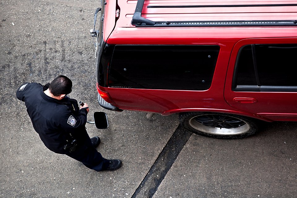 U.S. Customs and Border Protection Officer Inspects Vehicle