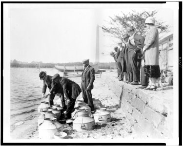 U.S. Fish Commissioner, Henry O'Malley, stocking fish in the Potomac River, at the Tidal Basin, Washington, D.C., with the Washington Monument in the background LCCN95502435