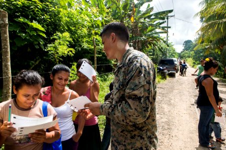 U.S. Marine Corps Cpl. Fredyjader Mendezbernal, center, attached to the Landing Attack Subsequent Operations team, speaks to Guatemalan patients at a medical civic action project (MEDCAP) in Puerto Barrios 140823-N-QY430-063