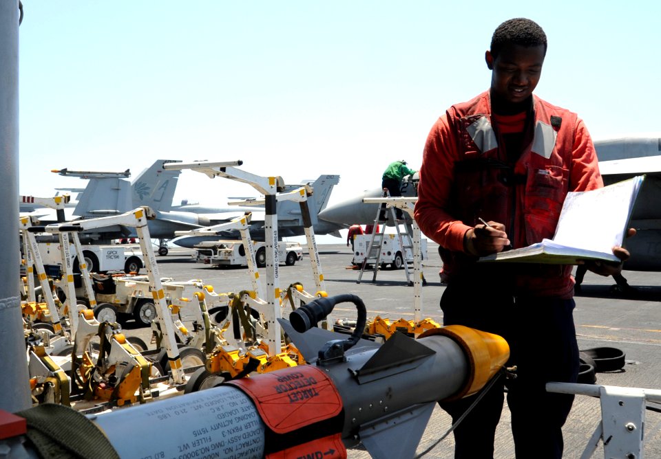 U.S. Navy Aviation Ordnanceman Airman Jeremy Brown updates an ordnance log aboard the aircraft carrier USS George H.W. Bush (CVN 77) in the Persian Gulf June 26, 2014 140626-N-MU440-028