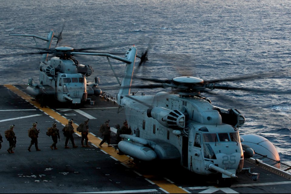 U.S. Marines assigned to the 31st Marine Expeditionary Unit (MEU) board a CH-53 Super Stallion helicopter attached to Marine Medium Tiltrotor Squadron (VMM) 265 on the flight deck of the amphibious assault ship 140310-N-LM312-034