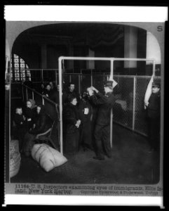 U.S. inspectors examining eyes of immigrants, Ellis Island, New York Harbor LCCN97501532 photo