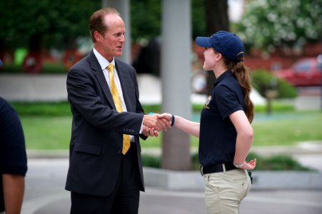 U.S. Marshal shakes hand with Police Explorer photo