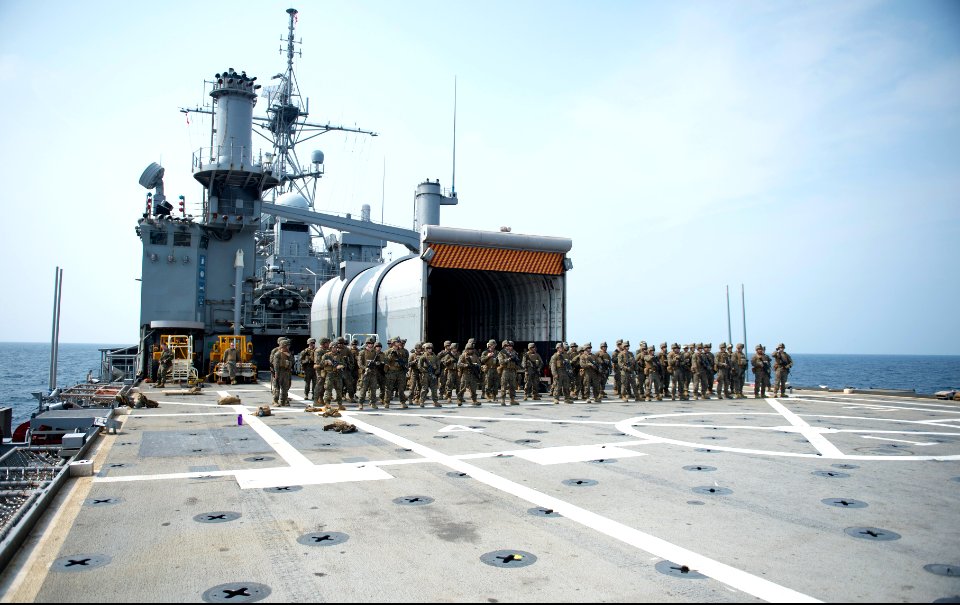 U.S. Marines assigned to Battalion Landing Team, 2nd Battalion, 5th Marine Regiment, 31st Marine Expeditionary Unit (MEU) prepare for a live-fire exercise aboard the amphibious transport dock ship USS Denver 140319-N-ZU025-211