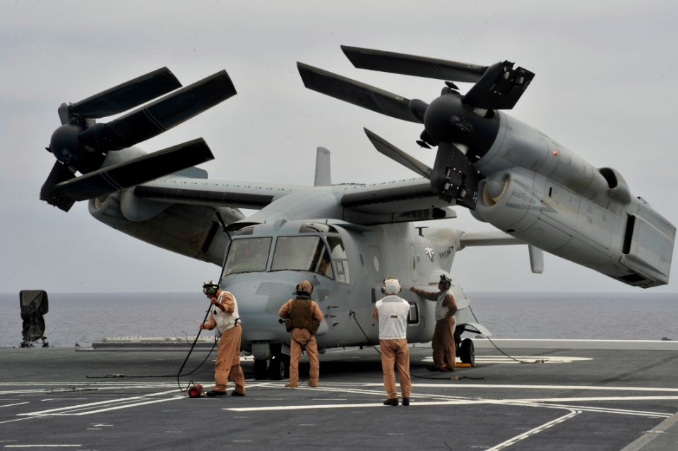 U.S. Marines inspect an MV-22 Osprey tilt-rotor aircraft