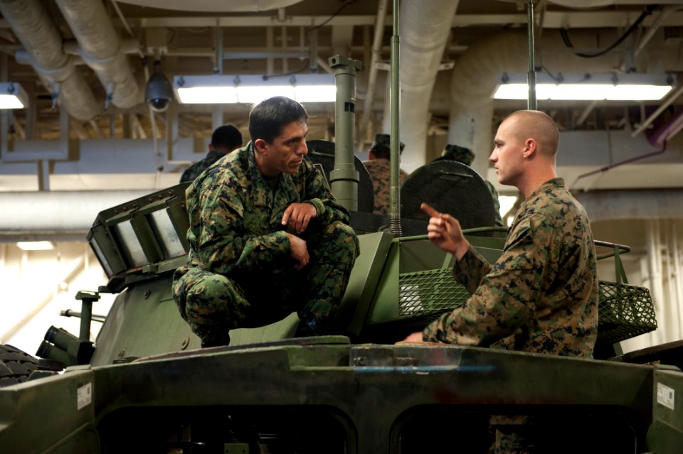 U.S. Marine Corps Lance Cpl. Zachary Cantrell, right, assigned to Special Purpose Marine Air-Ground Task Force South, talks to a Peruvian sailor about U.S. Marine Corps vehicle capabilities during a tour of 140902-N-MZ309-032
