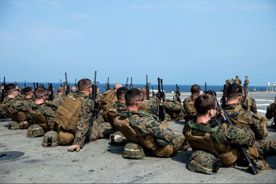 U.S. Marines assigned to Battalion Landing Team, 2nd Battalion, 5th Marine Regiment, 31st Marine Expeditionary Unit (MEU) prepare for a live-fire exercise aboard the amphibious transport dock ship USS Denver 140319-N-ZU025-043