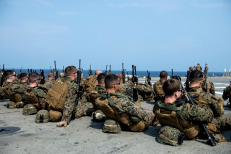U.S. Marines assigned to Battalion Landing Team, 2nd Battalion, 5th Marine Regiment, 31st Marine Expeditionary Unit (MEU) prepare for a live-fire exercise aboard the amphibious transport dock ship USS Denver 140319-N-ZU025-043