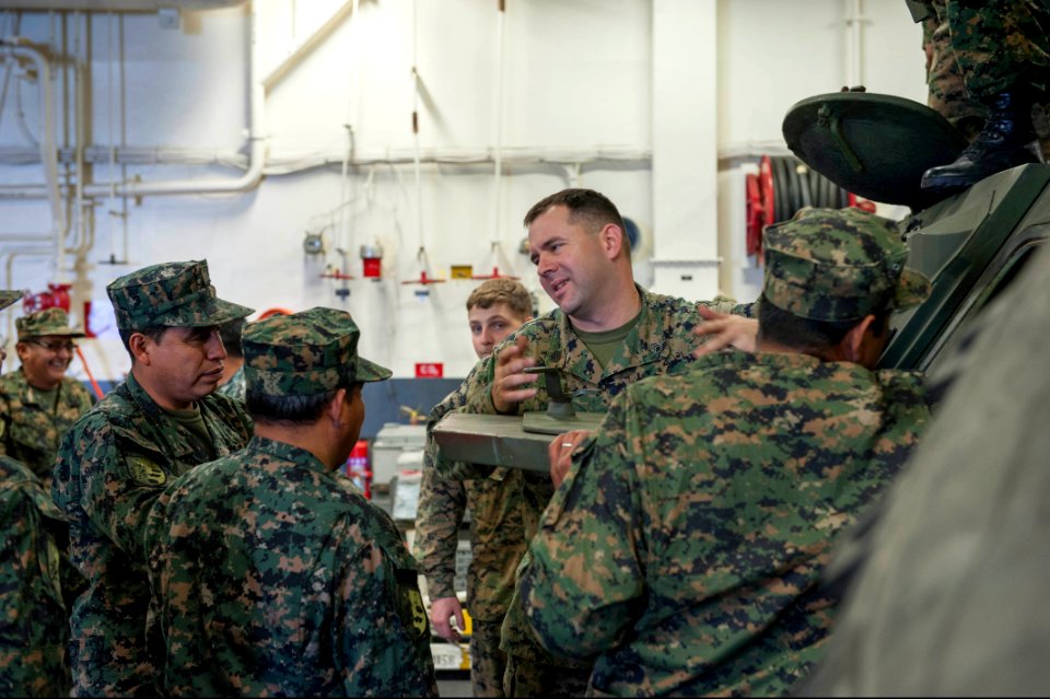 U.S. Marine Corps Staff Sgt. Christopher Chambers, second from right, assigned to Special Purpose Marine Air-Ground Task Force South, speaks with Peruvian sailors about U.S. Marine Corps vehicle capabilities 140902-N-MZ309-064