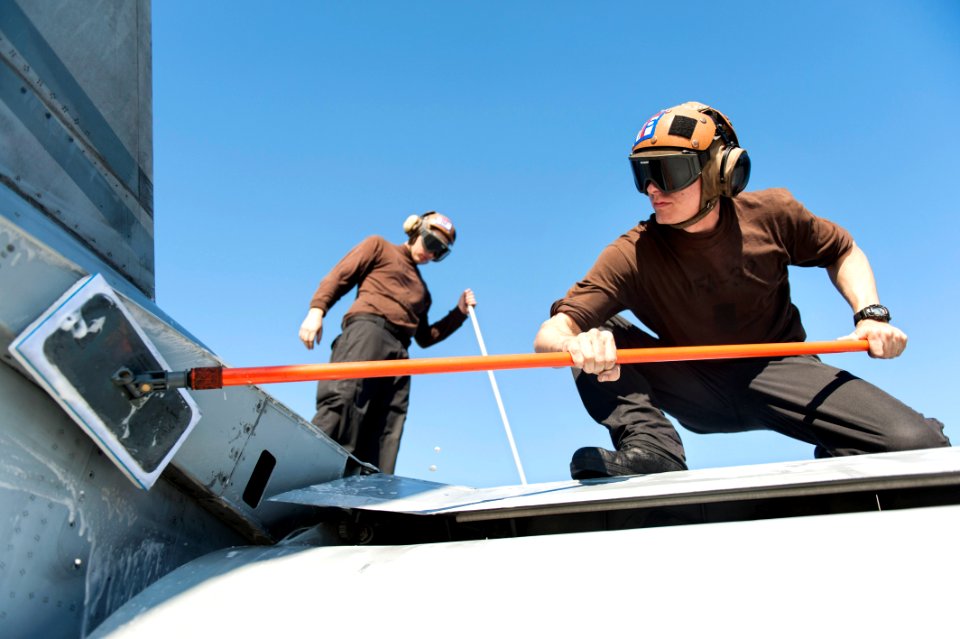 U.S. Navy Airman Mark Spencer, right, and Aircrew Survival Equipmentman Airman Drayton Pelham, both assigned to Strike Fighter Squadron (VFA) 32, wash an F-A-18F Super Hornet aircraft on the flight deck of 140216-N-ZG705-432