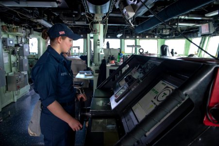 U.S. Navy Boatswain's Mate Seaman Recruit Natia Repine steers the ship while standing helmsman watch on the bridge of the guided missile destroyer USS Stout (DDG 55) in the Mediterranean Sea Jan. 15, 2014 140115-N-UD469-331