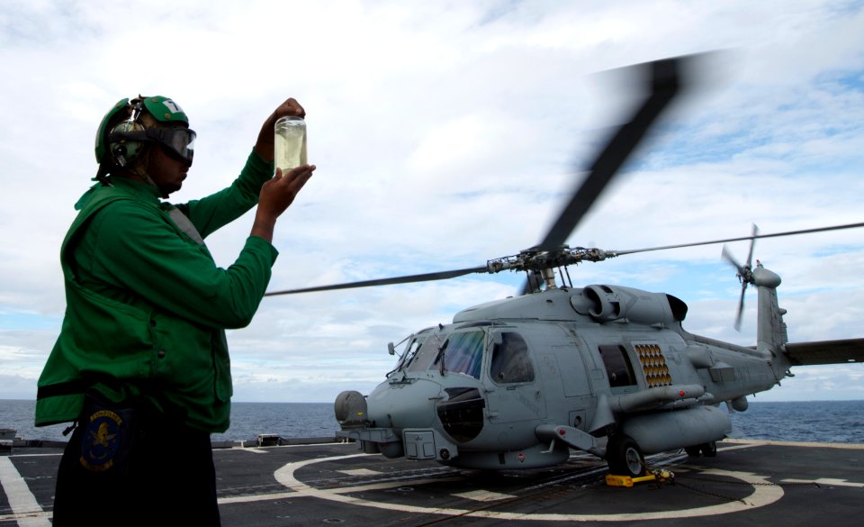 U.S. Navy Aviation Machinist's Mate 2nd Class Kevin Smith inspects fuel on the flight deck aboard the guided missile cruiser USS Philippine Sea (CG 58) in the Mediterranean Sea March 2, 2014 140302-N-PJ969-108