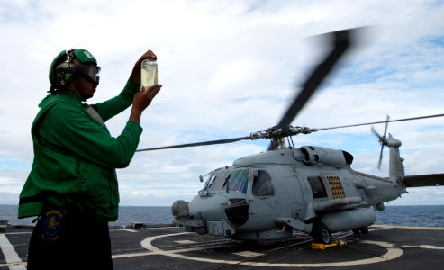 U.S. Navy Aviation Machinist's Mate 2nd Class Kevin Smith inspects fuel on the flight deck aboard the guided missile cruiser USS Philippine Sea (CG 58) in the Mediterranean Sea March 2, 2014 140302-N-PJ969-108