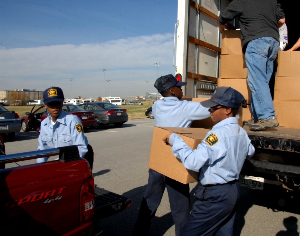 U.S. Naval Sea Cadet Kendall Kent moves a box of food