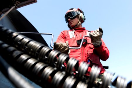 U.S. Marine Corps Cpl. Mark Alvarez, assigned to Marine Fighter Attack Squadron (VMFA) 312, loads ammunition onto an F-A-18C Hornet aircraft aboard the aircraft carrier USS Harry S. Truman (CVN 75) in the Gulf 140219-N-ZG705-590