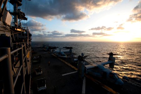 U.S. Marine Corps MV-22 Osprey tiltrotor aircraft and CH-53 Super Stallion helicopters attached to Marine Medium Tiltrotor Squadron (VMM) 265 are shown on the flight deck of the amphibious assault ship USS 140310-N-LM312-011