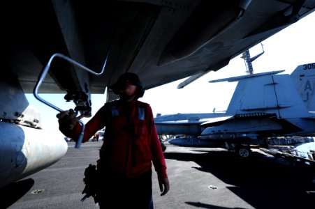 U.S. Navy Aviation Ordnanceman 2nd Class Nicolle Morris tightens a bolt on an F-A-18F Super Hornet aircraft assigned to Strike Fighter Squadron (VFA) 213 aboard the aircraft carrier USS George H.W. Bush (CVN 77) 140625-N-CZ979-001