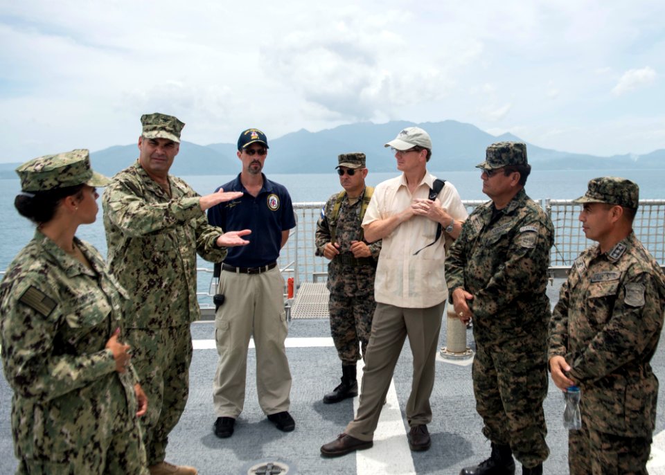 U.S. Navy Capt. Sam Hancock, second from left, the mission commander for Southern Partnership Station (SPS) 2014 operations aboard the joint high speed vessel USNS Spearhead (JHSV 1), speaks to U.S. and Honduran 140901-N-QY430-261