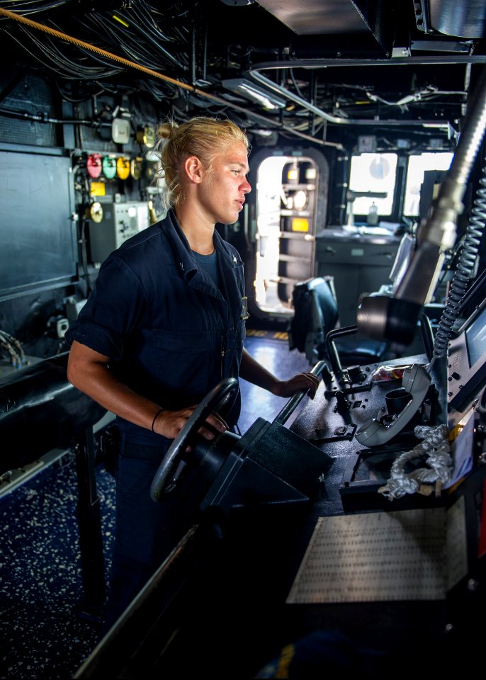 U.S. Navy Boatswain's Mate 3rd Class Cathryn Blauch mans the helm aboard the guided missile destroyer USS Truxtun (DDG 103) in the Persian Gulf June 27, 2014 140627-N-EI510-026