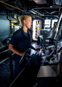 U.S. Navy Boatswain's Mate 3rd Class Cathryn Blauch mans the helm aboard the guided missile destroyer USS Truxtun (DDG 103) in the Persian Gulf June 27, 2014 140627-N-EI510-026
