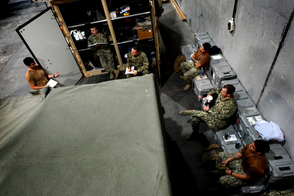 U.S. Navy Chief Hull Maintenance Technician Mario Pais, left, assigned to an unmanned underwater vehicle team with Commander, Task Group (CTG) 56 140209-N-OU681-012