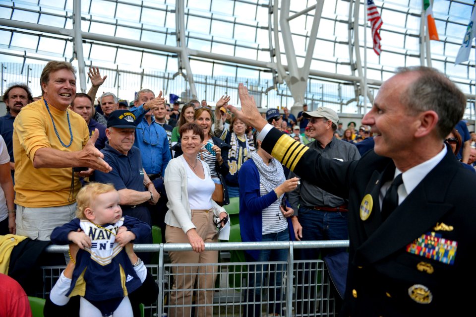 U.S. Navy Chief of Naval Operations Adm. Jonathan Greenert, right, waves to the crowd during the University of Notre Dame versus Navy Midshipmen NCAA Emerald Isle Classic college football season opener game 120901-N-WL435-675