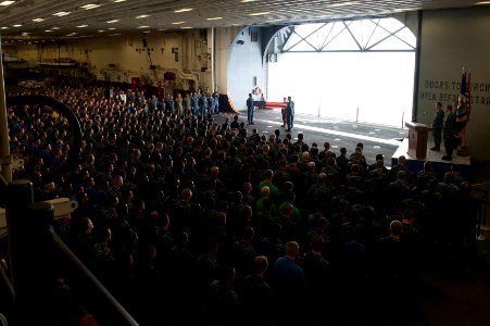 U.S. Navy chief petty officer selectees fold a U.S. flag as part of a 9-11 remembrance ceremony in the hangar bay of the newly commissioned amphibious assault ship USS America (LHA 6) Sept 140911-N-LQ799-174 photo