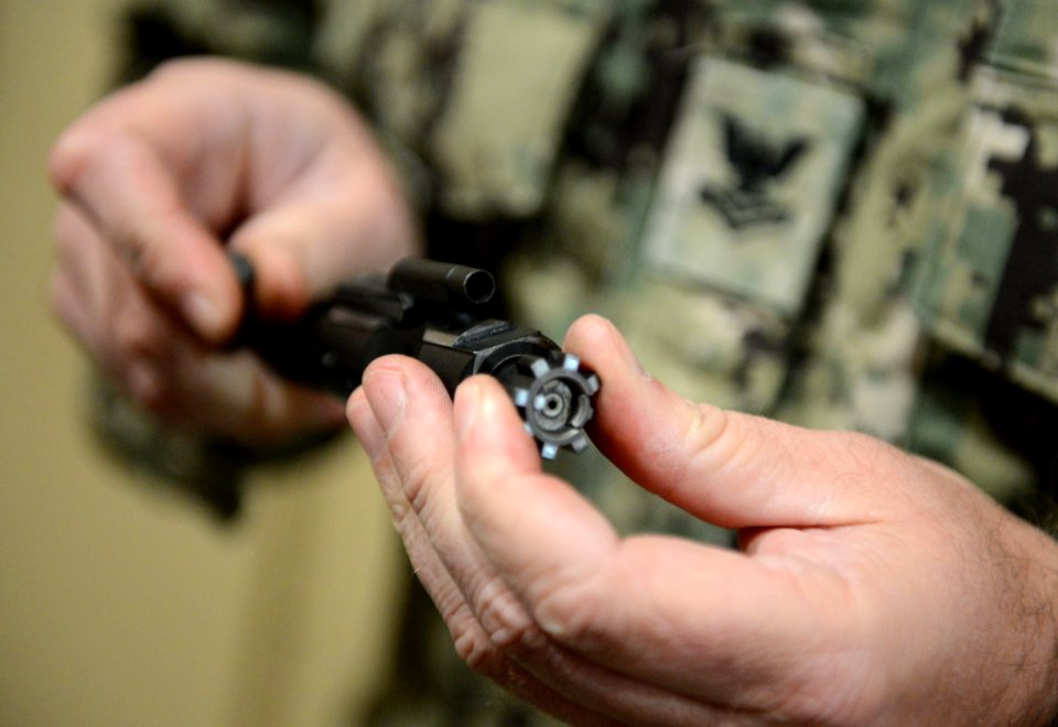 U.S. Navy Boatswain's Mate 2nd Class Stephen Wodraska, assigned to Commander, Task Force (CTF) 56, assembles an M4 carbine bolt carrier group during weapons training at Naval Support Activity Bahrain in Manama 140212-N-OU681-043