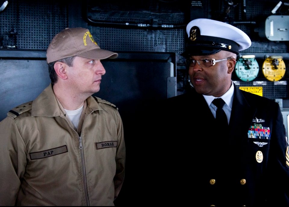 U.S. Navy Command Master Chief Albert McCurdy, right, speaks with Romanian Navy Warrant Officer Daniel Pap on the bridge aboard the guided missile destroyer USS Truxtun (DDG 103) in Constanța, Romania, March 8, 2 140308-N-EI510-011