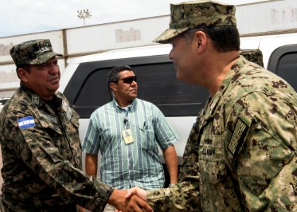 U.S. Navy Capt. Sam Hancock, right, the mission commander for Southern Partnership Station (SPS) 2014 operations aboard the joint high speed vessel USNS Spearhead (JHSV 1), greets a Honduran military official 140901-N-QY430-088
