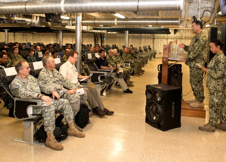 U.S. Navy Capt. Sam Hancock, second from right, the mission commander for Southern Partnership Station (SPS) 2014 operations aboard the joint high speed vessel USNS Spearhead (JHSV 1), speaks to U.S 140901-N-QY430-127