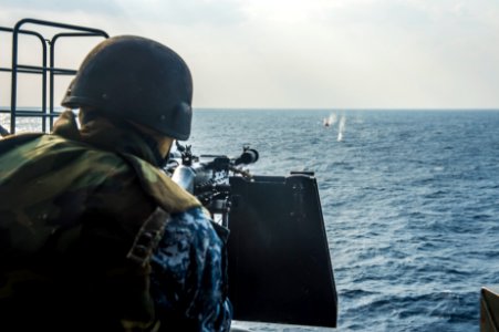 U.S. Navy Electronics Technician 3rd Class Dillon Fair fires an M240B machine gun during a live-fire exercise aboard the amphibious transport dock ship USS Denver (LPD 9) March 10, 2014, in the East China Sea 140310-N-ZU025-092