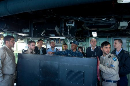 U.S. Navy Ensign Katherine Bermudez, center, gives Israeli Naval Forces sailors a tour of the bridge of the guided missile destroyer USS Stout (DDG 55) in Haifa, Israel, Jan. 20, 2014, during a scheduled port 140120-N-UD469-097