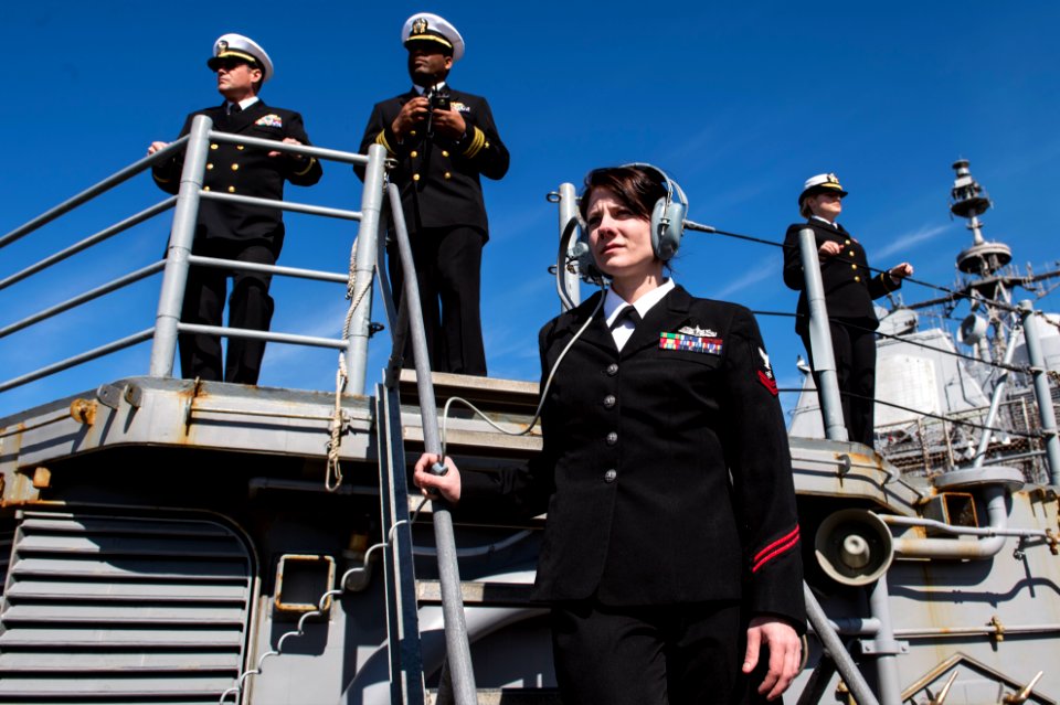 U.S. Navy Electronics Technician 2nd Class Sarah Parrish, foreground, stands phone talker watch aboard the guided missile cruiser USS Philippine Sea (CG 58) while moored in Piraeus, Greece, for a scheduled 140304-N-PJ969-399
