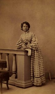 Unidentified standing Hawaiian woman, photograph by H. L. Chase, Mission Houses Museum Archives