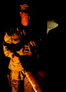 U.S. Navy Builder 1st Class Edward Krueger, selected as a chief petty officer assigned to Naval Mobile Construction Battalion 25, helps fold a ceremonial U.S. flag flown in remembrance of 9-11 at the New Kabul 140911-N-JP566-222 photo