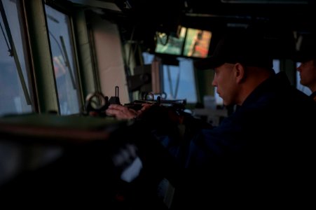 U.S. Navy Chief Warrant Officer Travis Meyer takes a bearing aboard the guided missile destroyer USS Stout (DDG 55) as the ship prepares to pull into port in Haifa, Israel, Jan. 19, 2014, for a scheduled port 140119-N-UD469-173