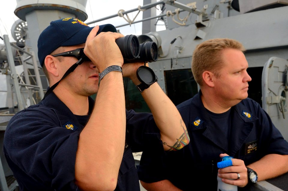 U.S. Navy Chief Master-at-Arms Jason Morris, left, stands watch monitoring civilian merchant traffic aboard the guided missile destroyer USS Ross (DDG 71) in the Dardanelles en route to the Black Sea Sept 140903-N-IY142-089