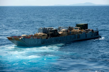 U.S. Navy Landing Craft Utility 1633 leaves the well deck of the amphibious assault ship USS Bonhomme Richard (LHD 6) in the East China Sea March 11, 2014 140311-N-LM312-072