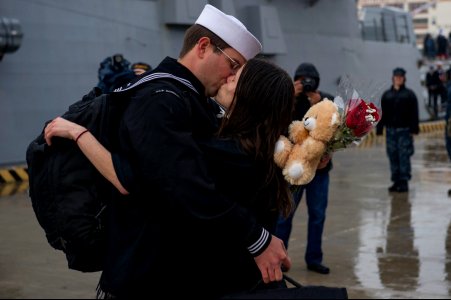 U.S. Navy Cryptologic Technician (Collection) 2nd Class Christopher Ferguson kisses his girlfriend after the guided missile destroyer USS Bainbridge (DDG 96) returned to Naval Station Norfolk, Va., Jan. 14 140114-N-VC236-083