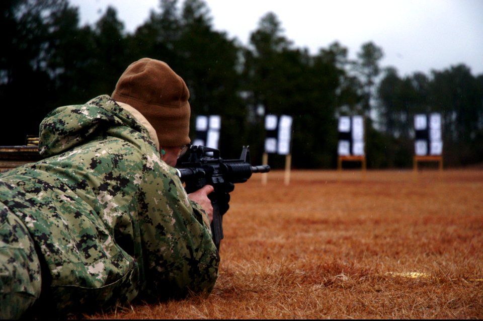 U.S. Navy Construction Mechanic 2nd Class Edson Felismino takes aim during Naval Construction Group 2's M4-M16 qualification course in Woolmarket, Miss., Feb. 11, 2014 140211-N-JP566-131