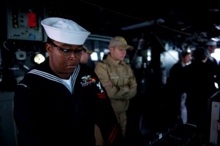 U.S. Navy Gunner's Mate 2nd Class Andrew Spivey, left, stands watch aboard the guided missile destroyer USS Truxtun (DDG 103) as it prepares to pull into Constanța, Romania, March 8, 2014 140308-N-EI510-289