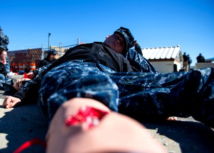 U.S. Navy Master-at-Arms Seamen Recruit Benjamin Kilgore acts as a simulated casualty Feb. 27, 2014, during a vehicle-borne improvised explosive device response exercise as part of Solid Curtain-Citadel Shield 140227-N-XQ474-135