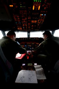 U.S. Navy Lt. j.g. Nick Horton, left, and Lt. Clayton Hunt, naval aviators assigned to Patrol Squadron (VP) 16, perform preflight checks in the flight station of a P-8A Poseidon aircraft before a mission to 140401-N-VD564-048