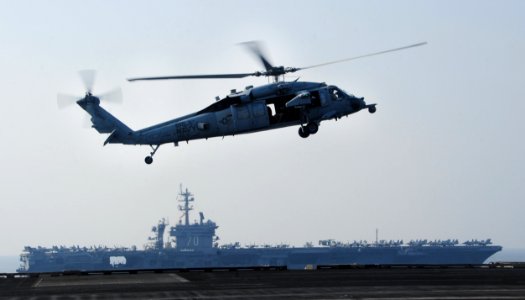 U.S. Navy MH-60S Seahawk helicopter assigned to Helicopter Sea Combat Squadron (HSC) 9 lands on the flight deck of the aircraft carrier USS George H.W. Bush (CVN 77) in the Persian Gulf as the aircraft carrier 141018-N-CZ979-004