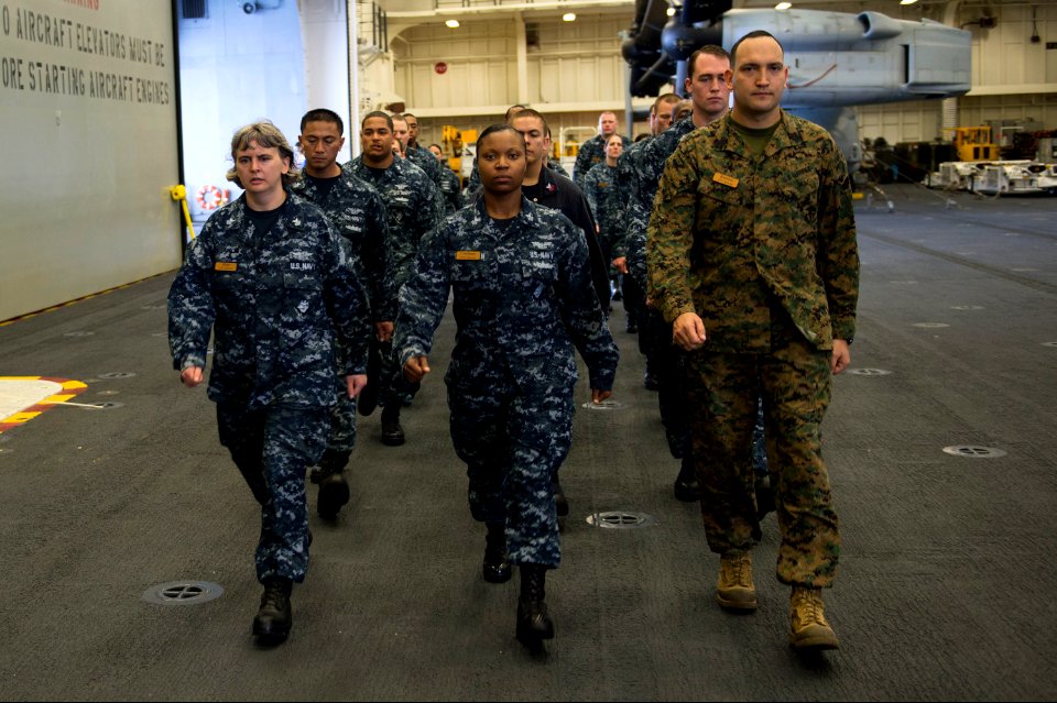 U.S. Navy petty officers 1st class selected for promotion to chief petty officer and Marine Corps Master Sgt. Jesse Ramirez, right, all assigned to the amphibious assault ship USS America (LHA 6), practice 140907-N-MD297-098