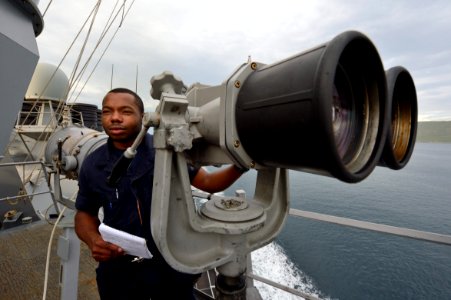 U.S. Navy Intelligence Specialist Seaman Ronald Freeman observes outbound civilian merchant traffic aboard the guided missile destroyer USS Ross (DDG 71) in the Dardanelles en route to the Black Sea Sept 140903-N-IY142-059